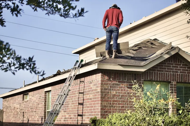 Professional roofer working on a residential roof in Perryville